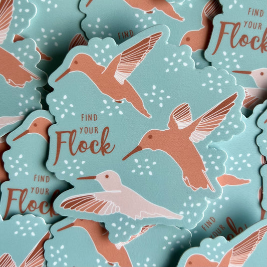 Aqua blue background with 3 hummingbirds in shades of peachy pink, with text saying "Find Your Flock"