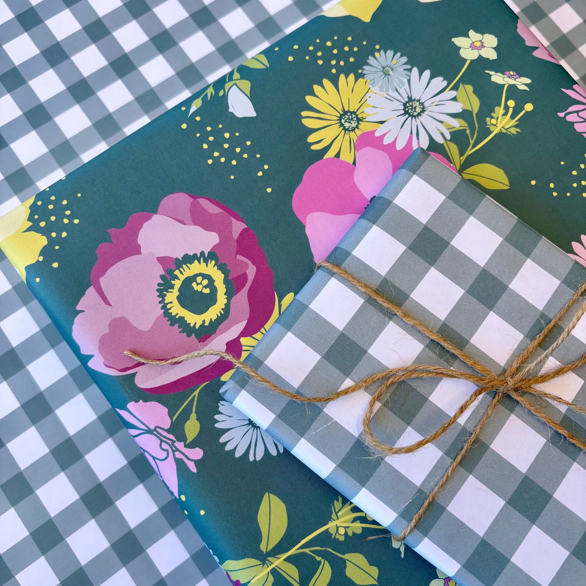 pile of gift boxes wrapped in teal gingham and a teal floral print