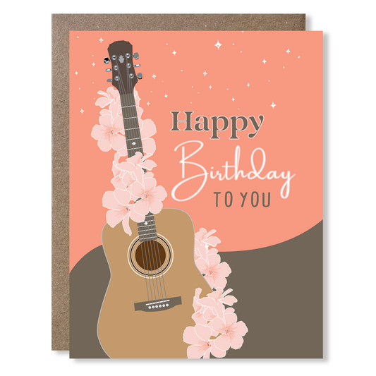 Birthday card with a guitar and cherry blossoms on a pink background