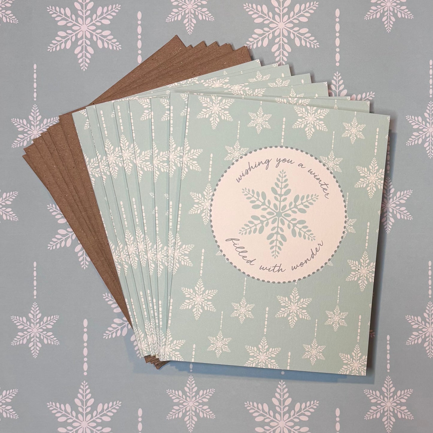 Set of greeting cards with snowflake design on a light blue background with snowflake pattern