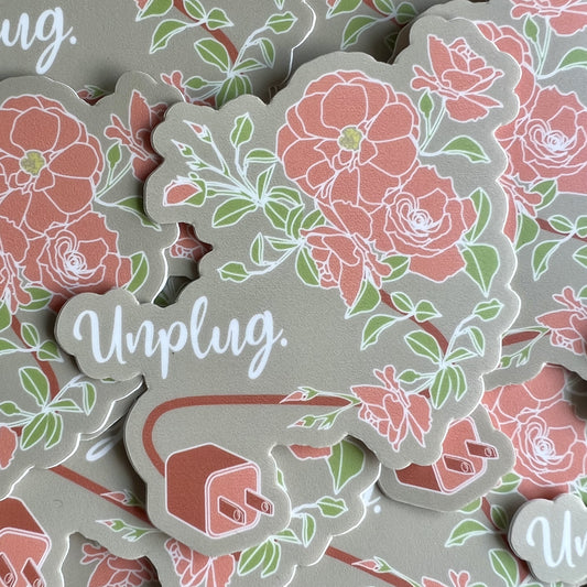 Khaki background sticker with a pink plug and a cord that turns into a stem for blossoming roses. Text reads "Unplug".