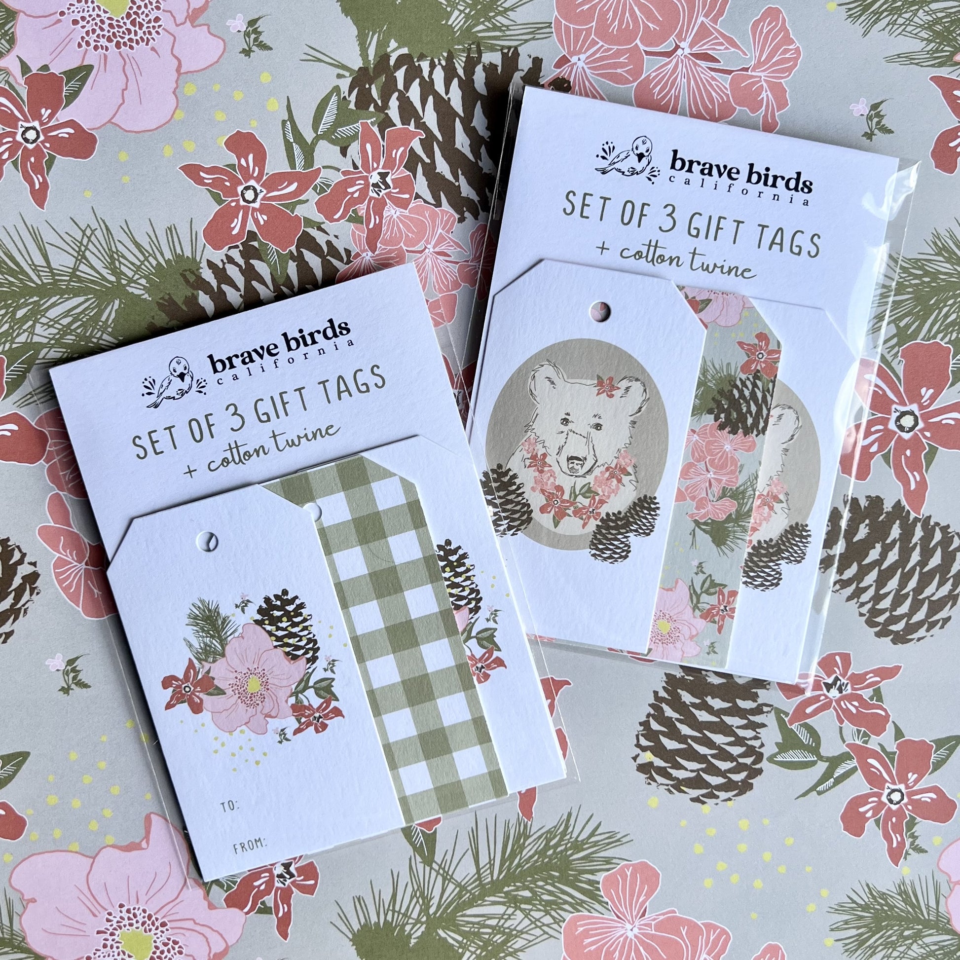 Packaged 3-packs of bear floral and floral gingham gift tags, with card backings and clear envelopes - text on each card backing reads "set of 3 gift tags + cotton twine"