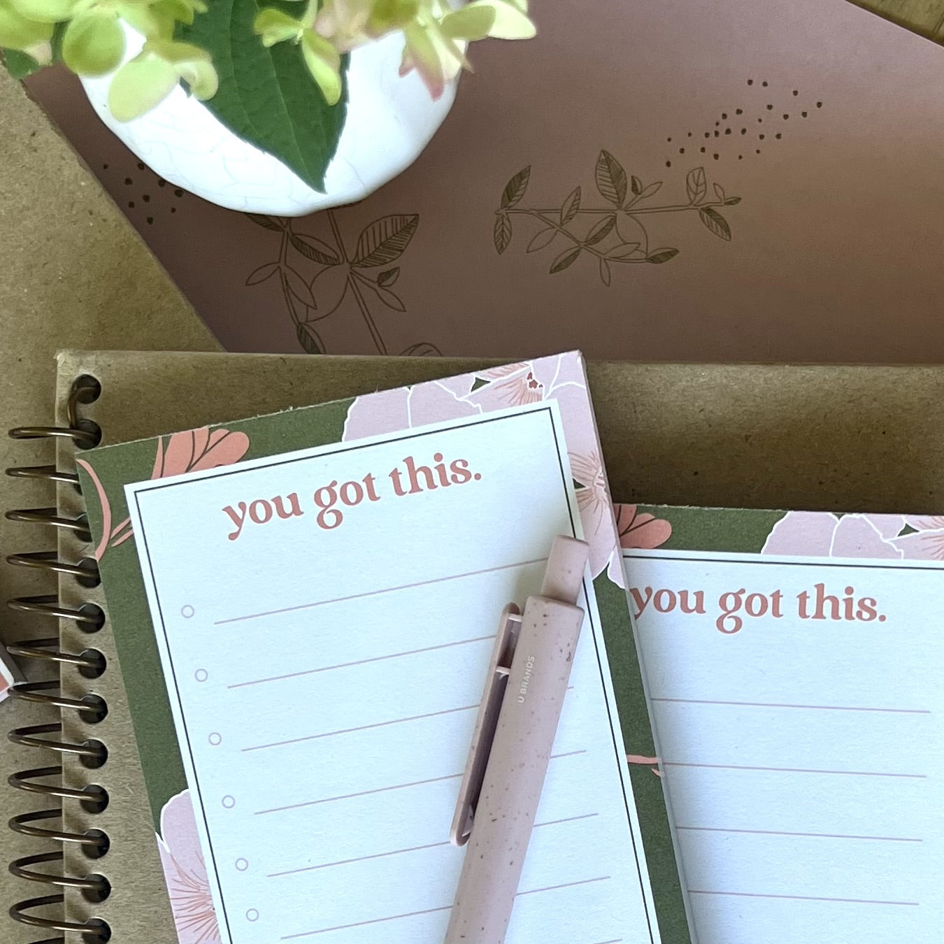 stack of 3 you got this notepads, styled with a pink pen, and other stationery items