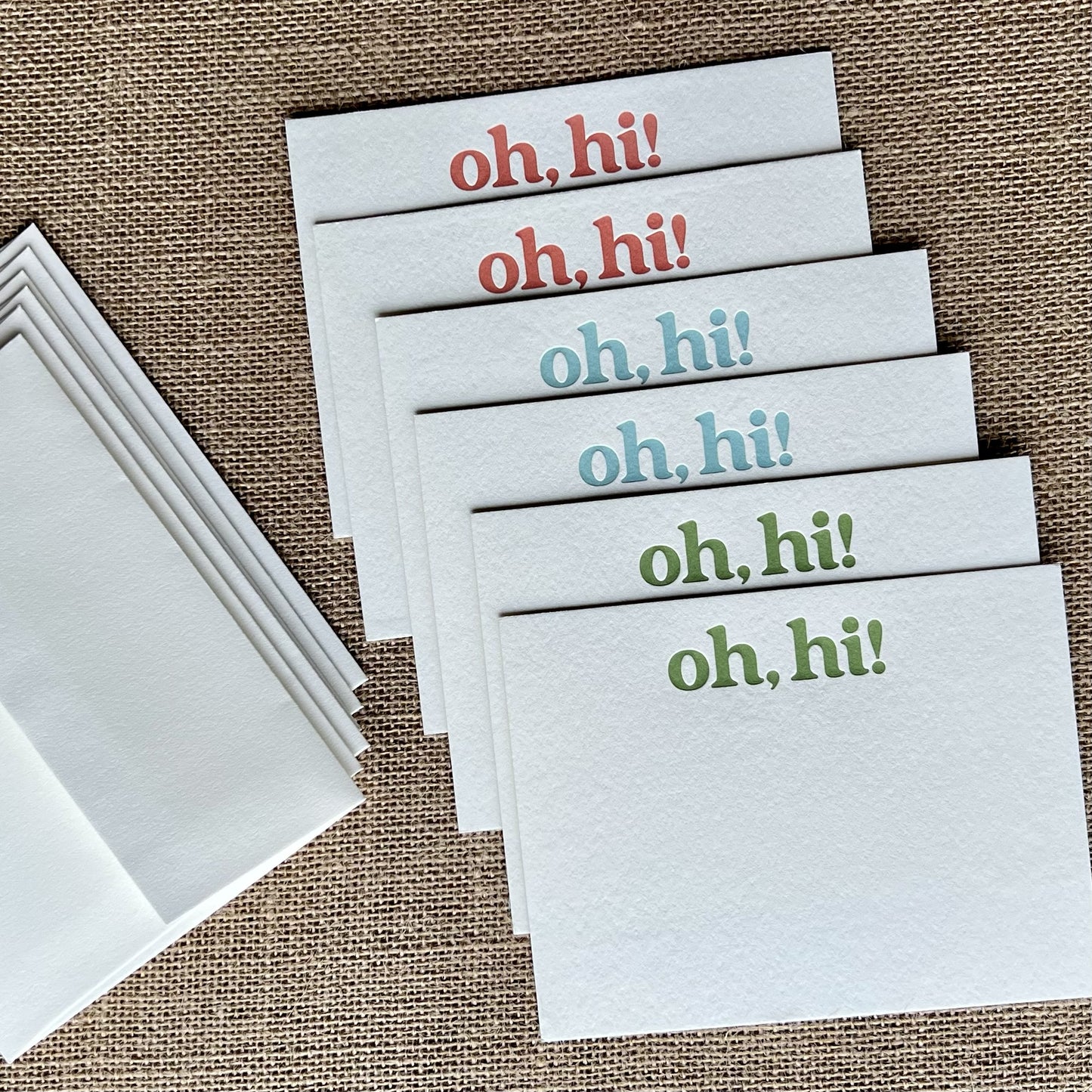 Six letterpress notecards, 2 printed in each of 3 colors - terracotta, aqua and green, shown fanned out with coordinating envelopes