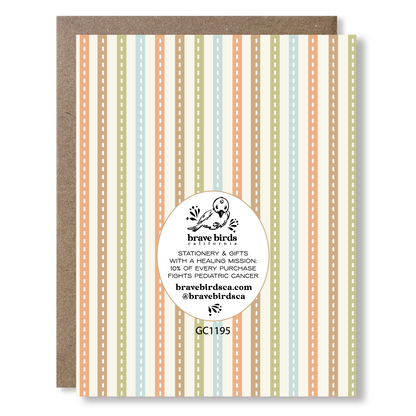 Back view of a greeting card with stripes, showing Brave Birds California logo and the text "stationery & gifts with a healing mission: 10% of every purchase fights pediatric cancer."