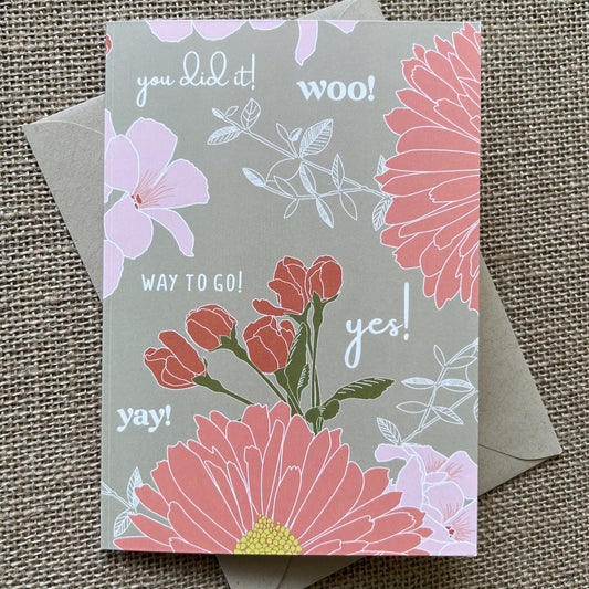 khaki background with warm pink tones in a flower print. White type says words like "you did it!" and "Way to go!" Shown with a kraft paper envelope