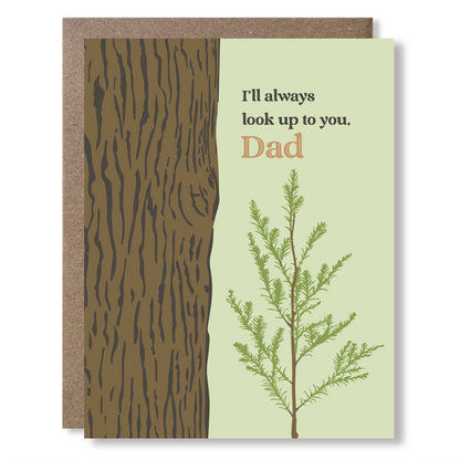 Greeting card with illustration of a sapling next to a huge tree trunk, with text reading "I'll always look up to you, Dad"