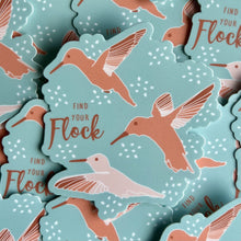 Load image into Gallery viewer, Aqua blue background with 3 hummingbirds in shades of peachy pink, with text saying &quot;Find Your Flock&quot;
