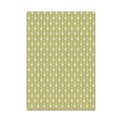 Patterned gift wrap sheet with a green background and organic shaped cream dots in a flower and stripe design