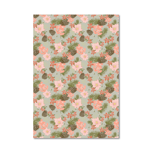 Gift wrap sheet with a repeating floral and pinecone pattern on a pale sage green background, shown against a plain white studio backdrop.
