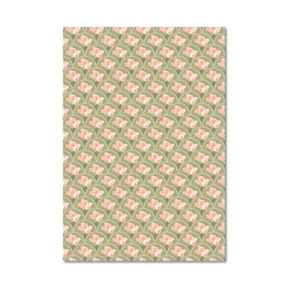 Patterned gift wrap sheet with a green background and pink flowers inside a white scallop shaped repeat design