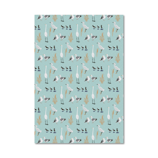 Patterned gift wrap sheet with a light blue background and a tossed print of illustrated sea birds like egrets and sea gulls