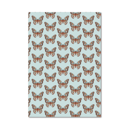 Patterned gift wrap sheet with an orange butterfly pattern on a light blue background
