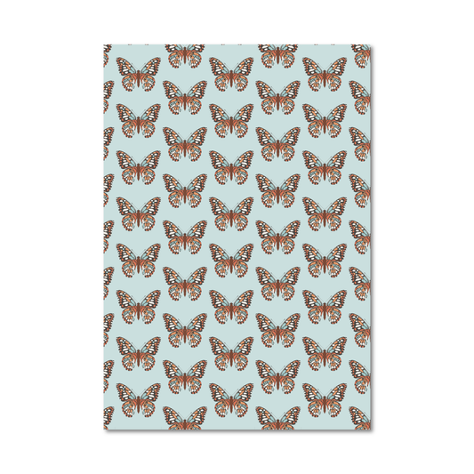 Patterned gift wrap sheet with an orange butterfly pattern on a light blue background