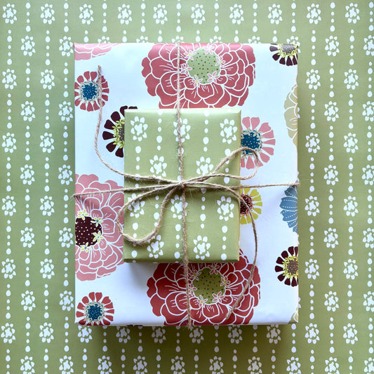 Two gift boxes with colorful floral and organic dot prints, tied with twine