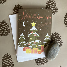 Load image into Gallery viewer, Holiday card with a nighttime forest scene, decorated tree and Santa sleigh silhouette flying in the starry sky. Text reads &quot;And to all a good night&quot; and the photo shows a single card and envelope.
