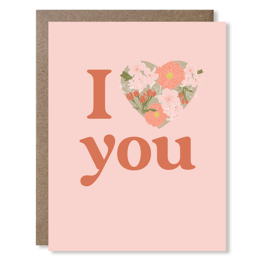 Greeting card with 'I heart you' text and floral design on a pink background