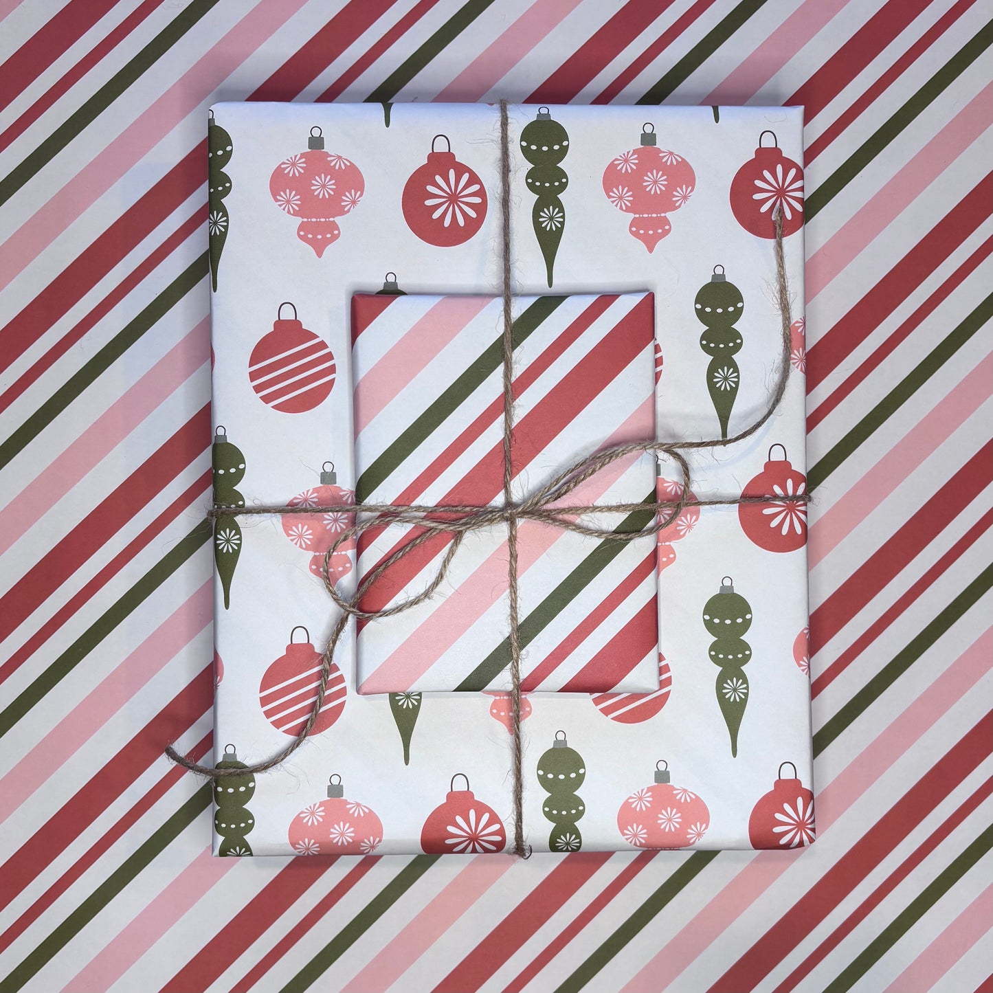 Gift boxes wrapped in festive candy cane stripe and ornament print red and green wrapping paper