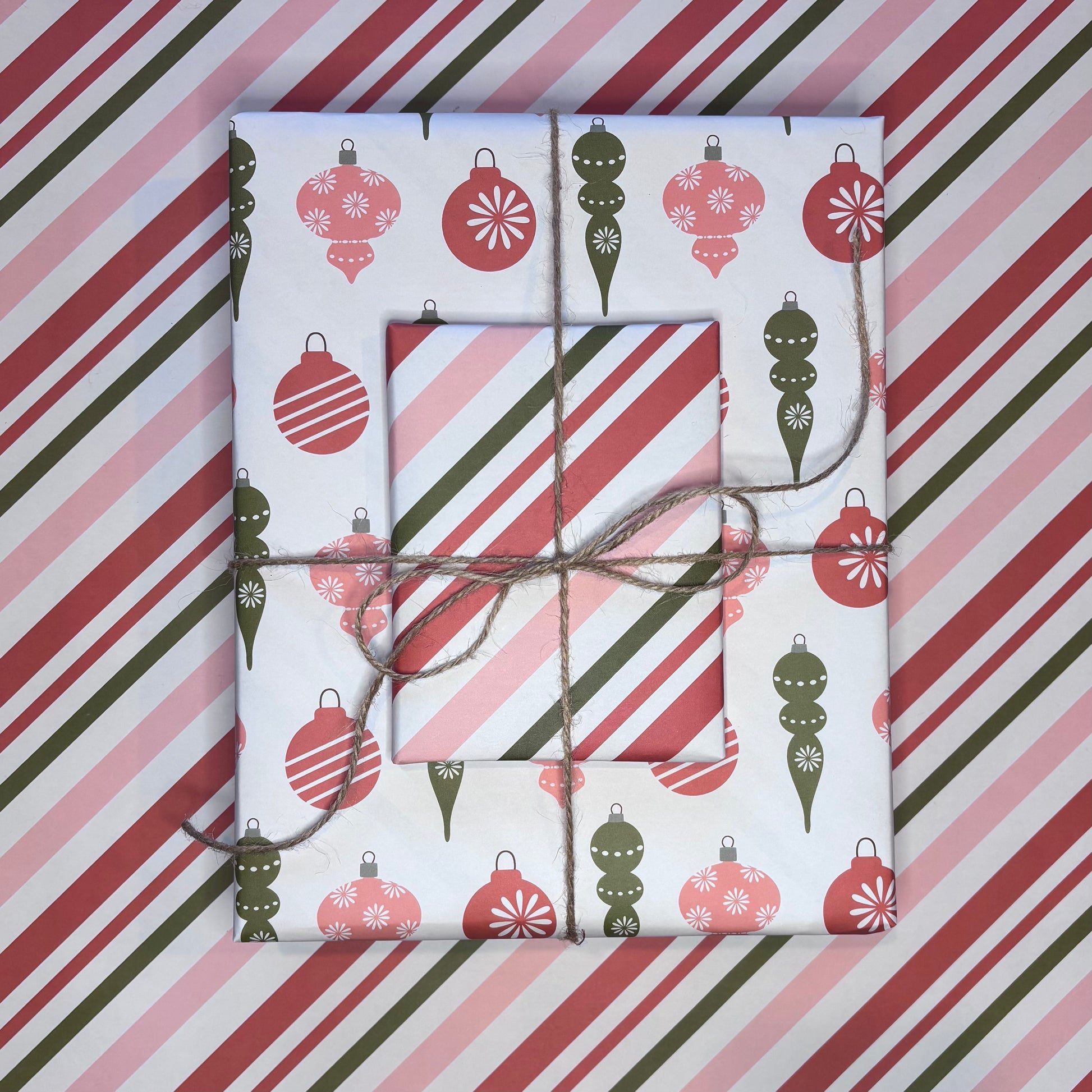 Gift boxes wrapped in festive candy cane stripe and ornament print red and green wrapping paper