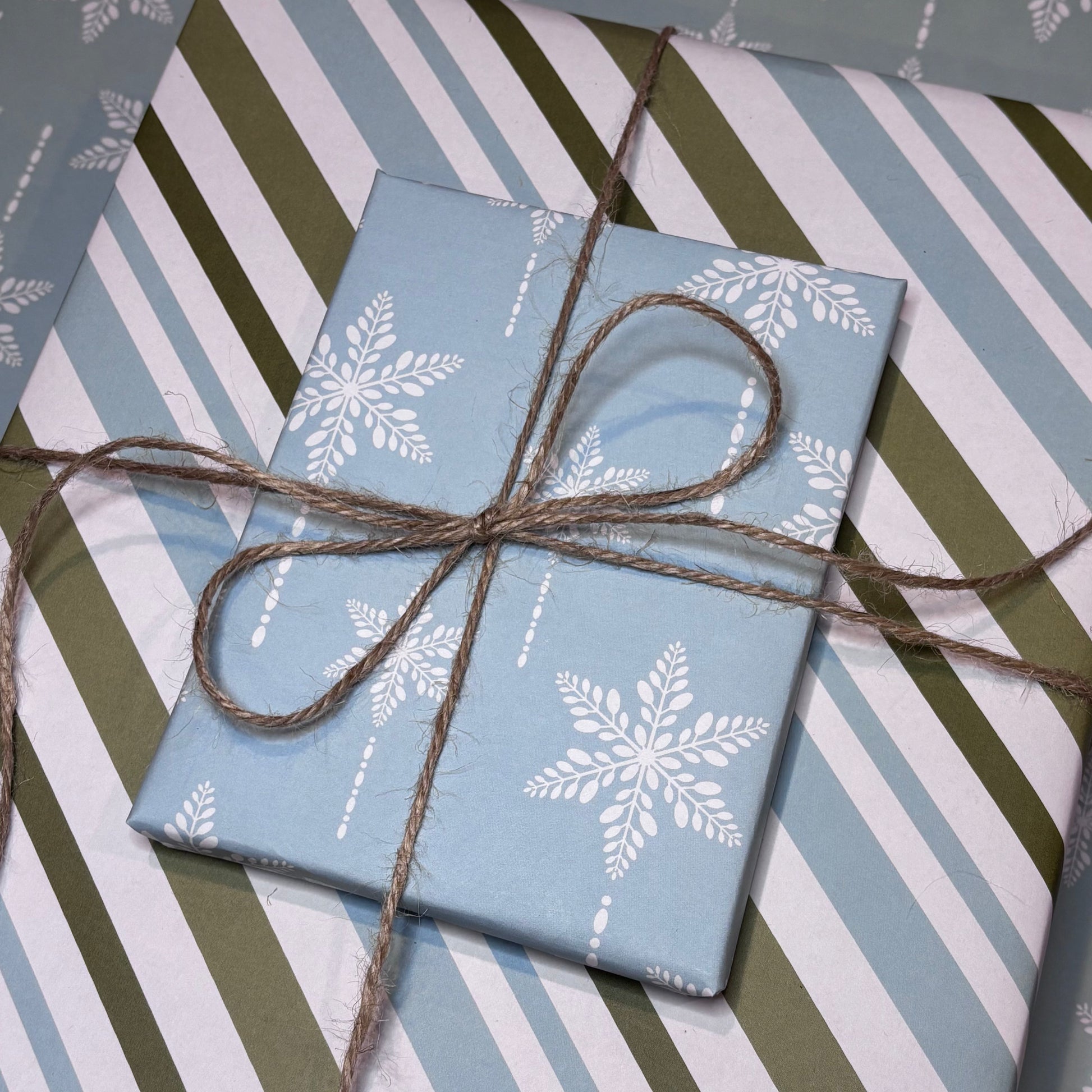 Gift boxes with snowflake and striped patterns tied with brown twine