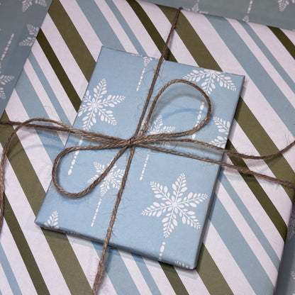 Gift boxes with snowflake and striped patterns tied with brown twine
