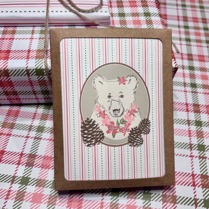 Card with bear illustration on a plaid fabric background