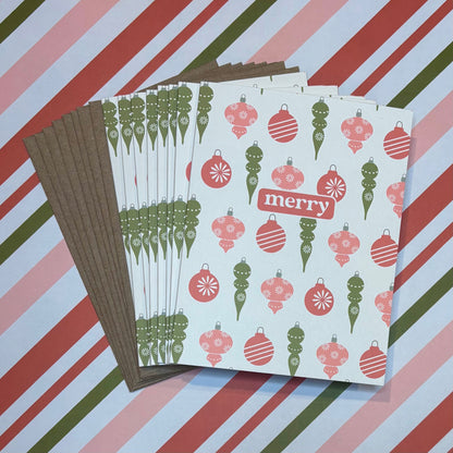 Stack of greeting cards with Christmas ornament design on a striped background