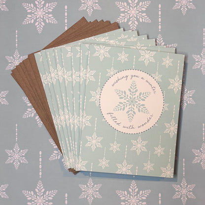 Set of greeting cards with snowflake design on a light blue background with snowflake pattern