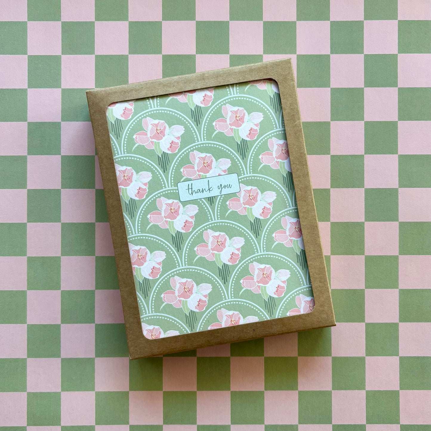 Box of cards featuring pink flower bunches on a green scallop pattern and the words thank you 