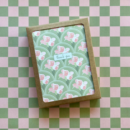 Box of cards featuring pink flower bunches on a green scallop pattern and the words thank you 