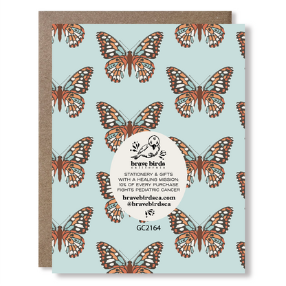 Back view of a greeting card with brand information reading "Brave Birds California, stationery & gifts with a healing mission: 10% of every purchase fights pediatric cancer"