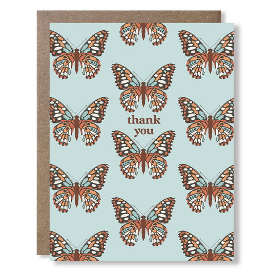 Greeting card with butterfly design and 'thank you' text on a light blue background