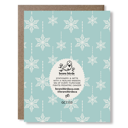 Greeting card back view with snowflake pattern and brand logo with text that reads 'stationery & gifts with a healing mission: 10% of every purchase fights pediatric cancer