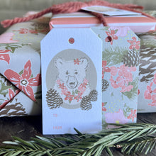 Load image into Gallery viewer, Gift wrapped package and two TO/FROM gift tags with an illustration of a bear with flower necklace and a flower in her ear on the front, an all-over floral print on the back..
