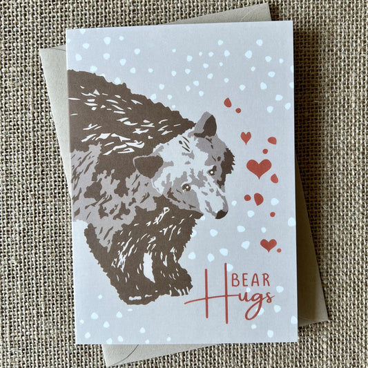 khaki background card with a brown bear illustration and text saying bear hugs with hearts in red