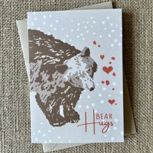 Load image into Gallery viewer, khaki background card with a brown bear illustration and text saying bear hugs with hearts in red
