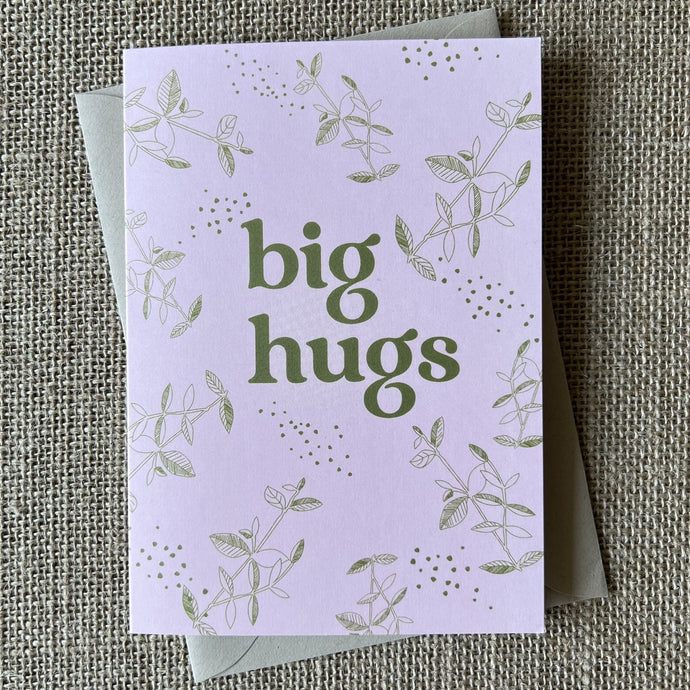 pale pink card with olive green branch and leaf illustrations and bold text saying big hugs