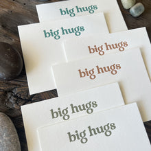 Load image into Gallery viewer, Closeup shot showing debossed texture of letterpress printed notecards that say &quot;big hugs&quot; in teal, olive and dark orange.
