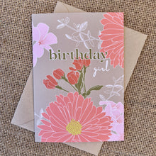 Load image into Gallery viewer, Greeting card with khaki background and pink flowers, text reading &quot;birthday girl&quot;, styled with a kraft envelope on a tan burlap background
