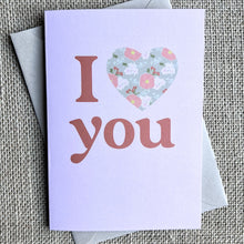 Load image into Gallery viewer, Greeting card with pink background and &quot;I love you&quot; written with a heart filled with a floral pattern
