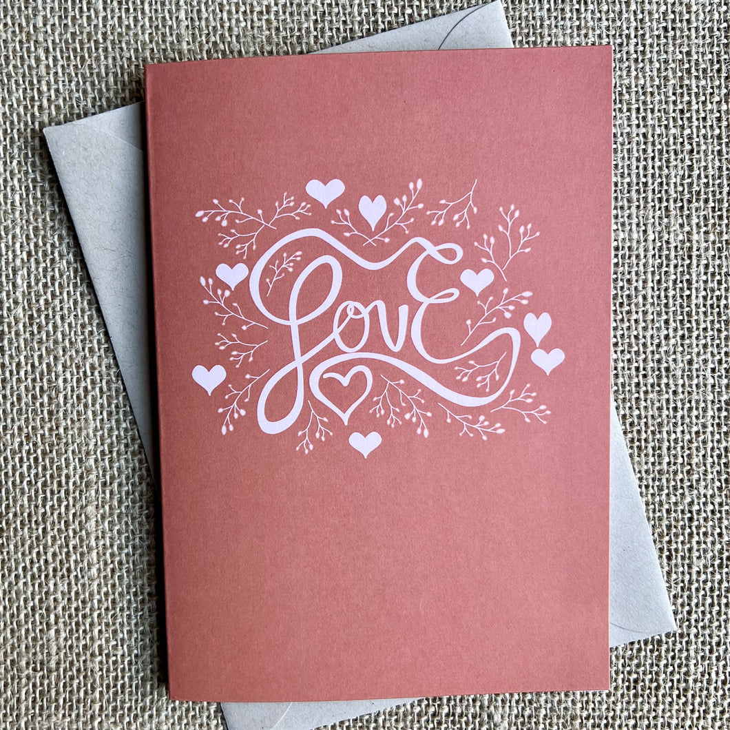 Greeting card with a warm red/pink background and a hand illustrated 