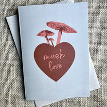 Load image into Gallery viewer, Khaki background greeting card with a red heart and pink mushrooms, text reading &quot;mush love&quot;
