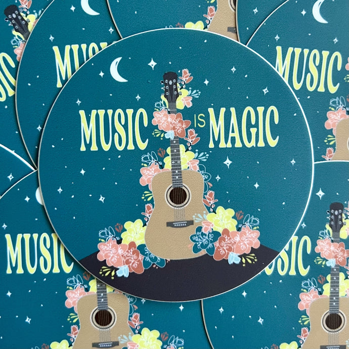 Pile of stickers featurign an illustration of a guitar draped in flowers and the words 