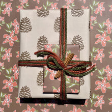 Load image into Gallery viewer, Giftwrapped package with two boxes, one in a khaki and brown pinecone pattern, one in a red and brown floral print
