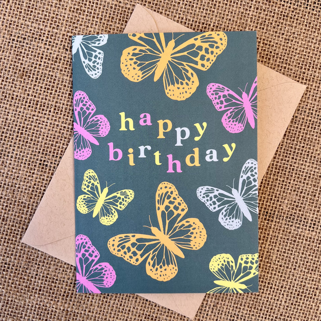 Greeting card with teal background and pink, orange and blue butterflies, text reading 