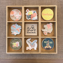 Load image into Gallery viewer, wooden box with nine square compartments, each holding a different sticker design
