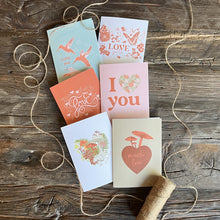 Load image into Gallery viewer, Six assorted valentine cards on a wood background, styled with twine
