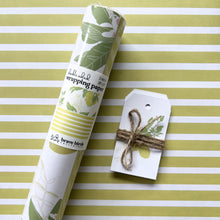 Load image into Gallery viewer, Packaged roll of wrapping paper  sitting on a flat sheet of the paper showing the full pattern, shown with coordinating gift tags
