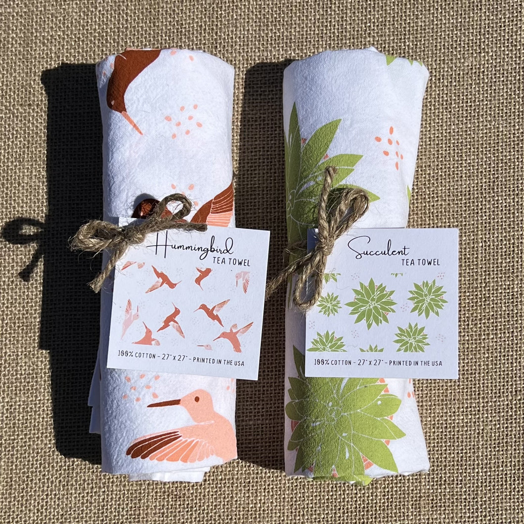 Two packaged tea towels, rolled up and tied with twine